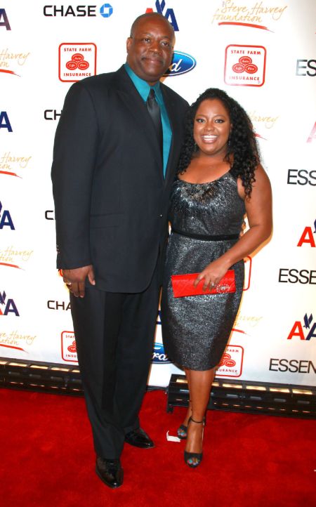 Sherri Shepherd poses for a picture in a black dress with Lamar Sally.